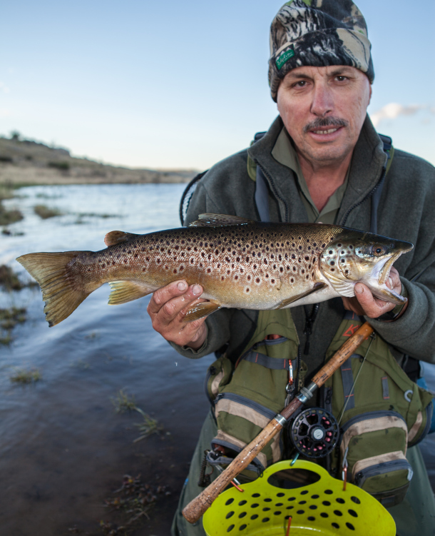 Chris Cleaver with his recently caught and released hybrid cod he likes to call a Murrout (cross between a Murray and trout cod).